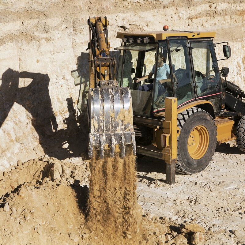 excavator digging in sand