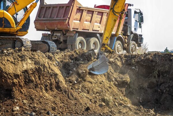 Construction site machines - dump truck and excavator