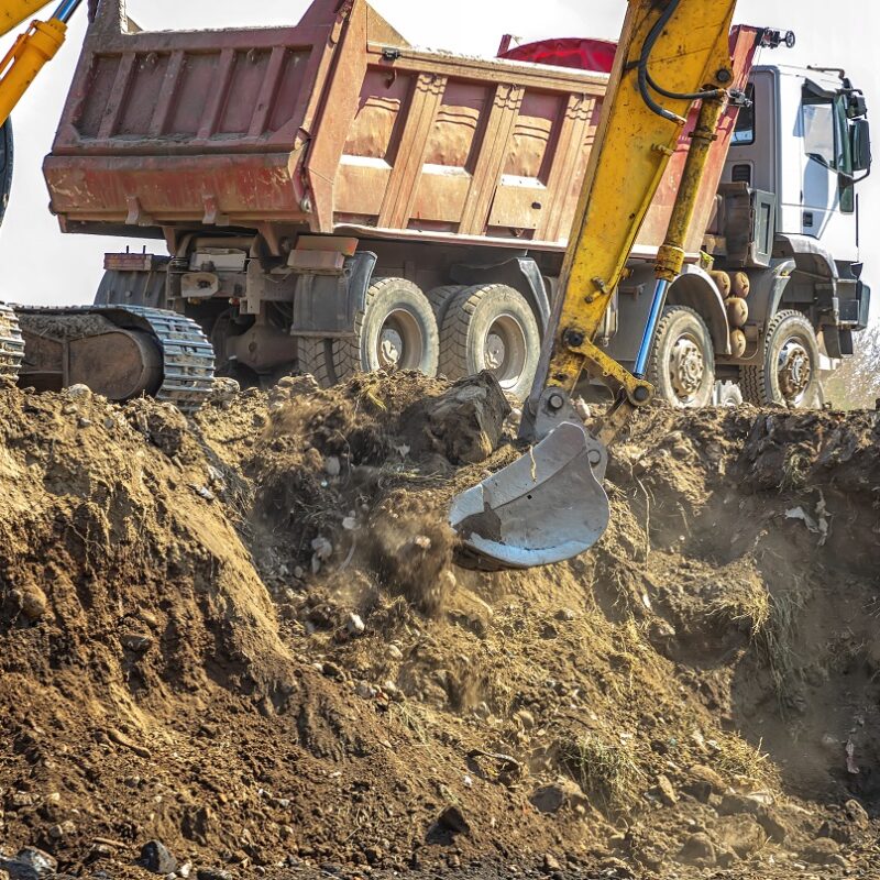 Construction site machines - dump truck and excavator