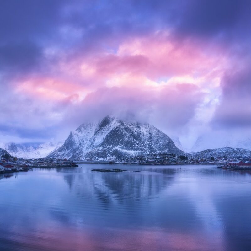 purple skies with snowy mountain and lake