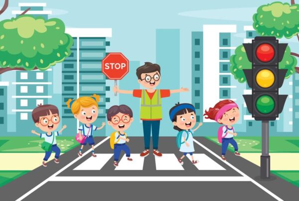 Crossing guard helping children cross the street
