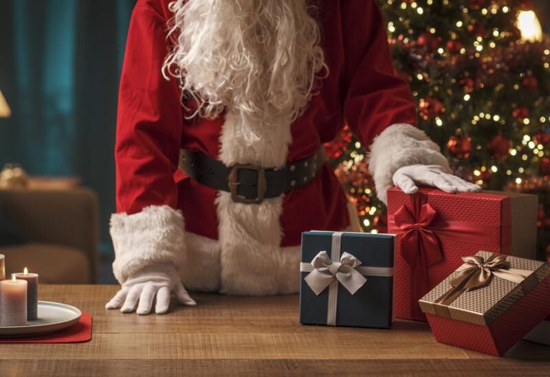 Santa Clause with his hand on presents backdrop